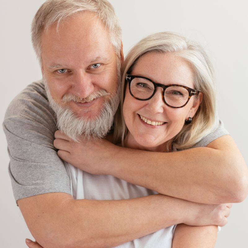 A senior couple embracing